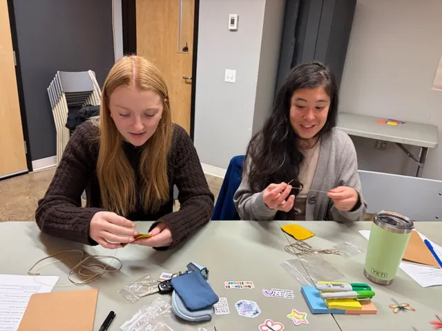 Participants seated together working with craft materials during the Wellness Gathering.